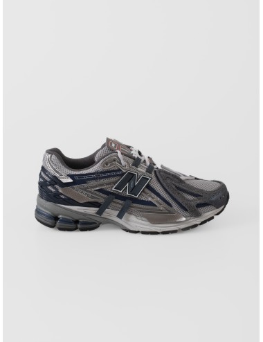 Sneaker gris New Balance 1906A con mesh, paneles irregulares grafito y azul magic blue