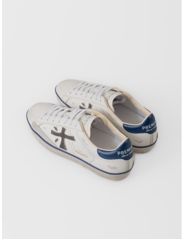 Zapatilla blanca Premiata Steven 7503 con logo lateral oscuro, talón azul y suela gráfica