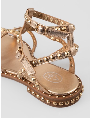 Sandalia plana dorada ASH Precious con tiras cruzadas, hebillas al tobillo y tachas metálicas